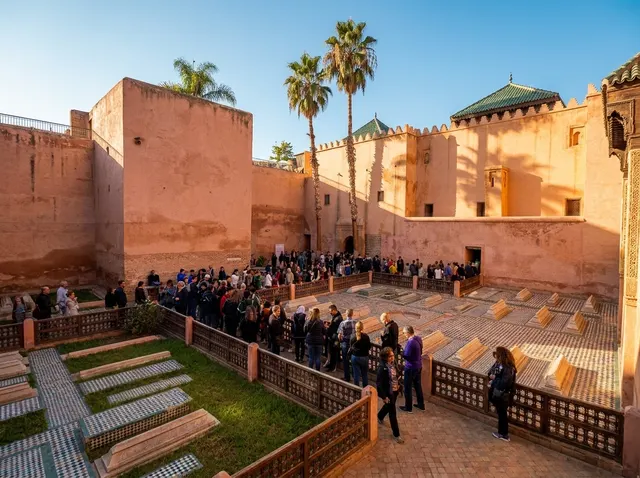 The walled garden of tombs seen from above, its tiled grave slabs laid out among visitors and palms